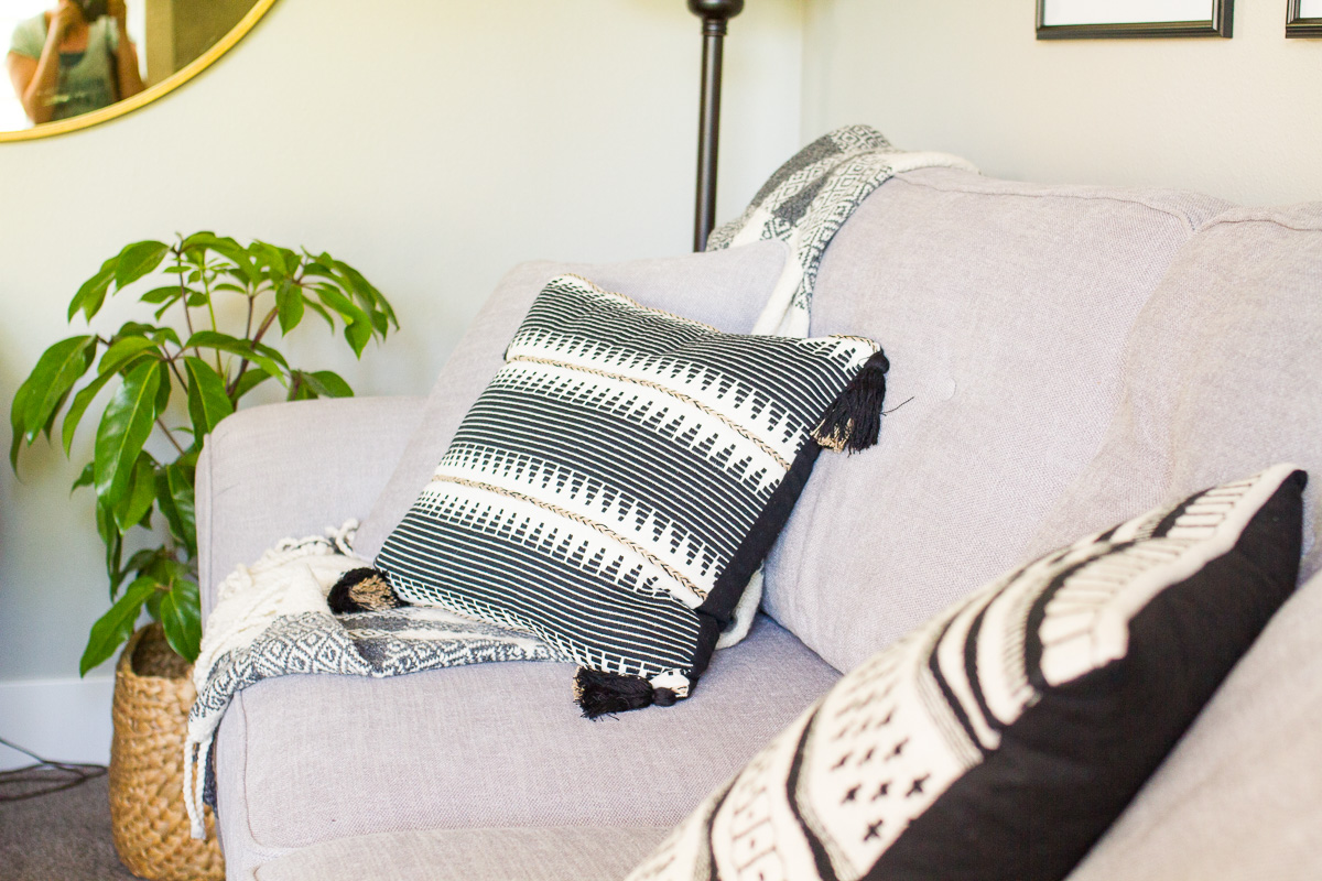 gray couch with black and white pillows