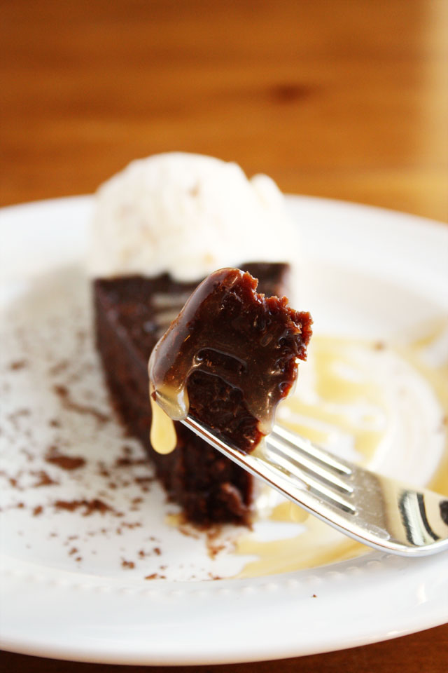 flourless chocolate cake with salted caramel sauce and whipped cream
