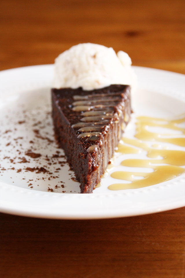 flourless chocolate cake with salted caramel drizzle and whipped cream