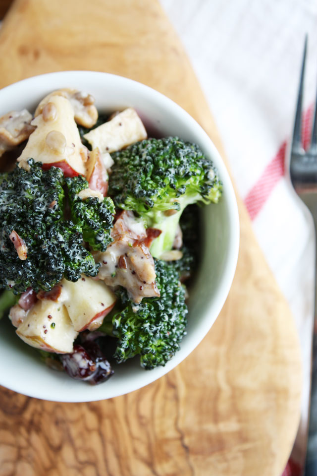 chopped broccoli salad with poppy seed dressing, bacon, apples, craisins, cashews, sunflower seeds, and red onion