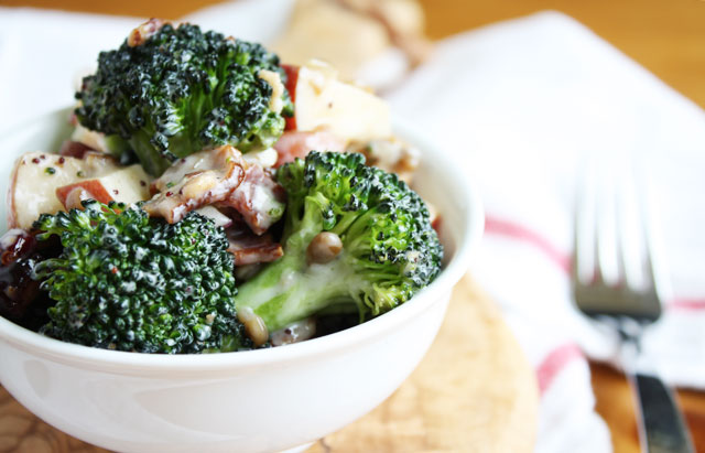 chopped broccoli salad with poppy seed dressing, bacon, apples, craisins, cashews, sunflower seeds, and red onion