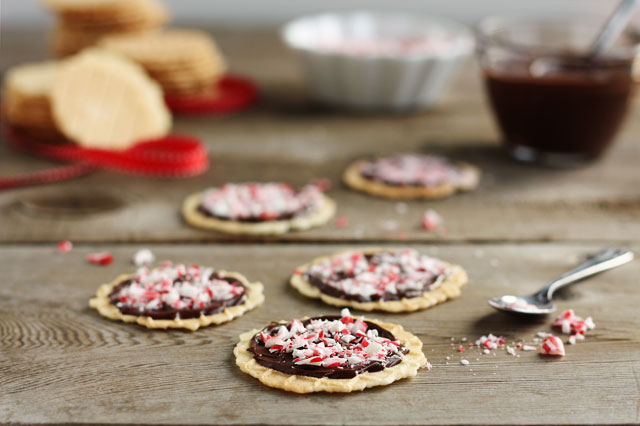 These buttery, wafer-tin waffle cookies are topped with rich chocolate and crushed peppermint!