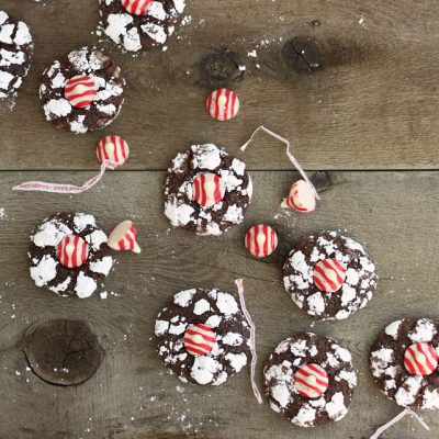 Theses chocolate crinkle cookies have just a hint of peppermint in them before they're rolled in powdered sugar and topped with a peppermint kiss!