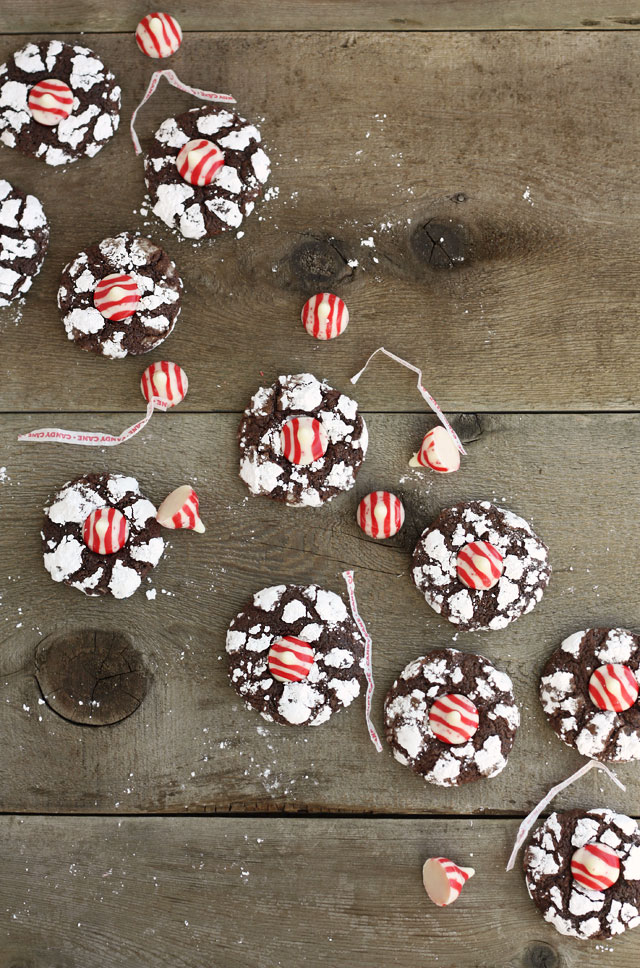 Theses chocolate crinkle cookies have just a hint of peppermint in them before they're rolled in powdered sugar and topped with a peppermint kiss!