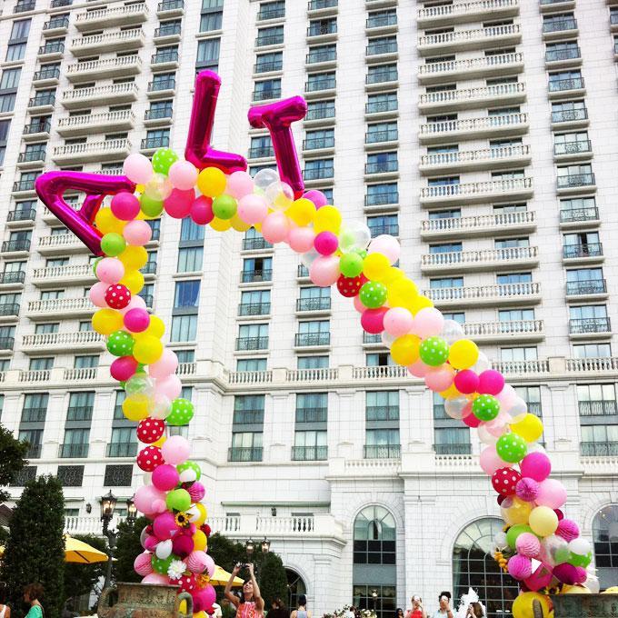 alt summit giant balloon arch with flowers and honeycomb balls