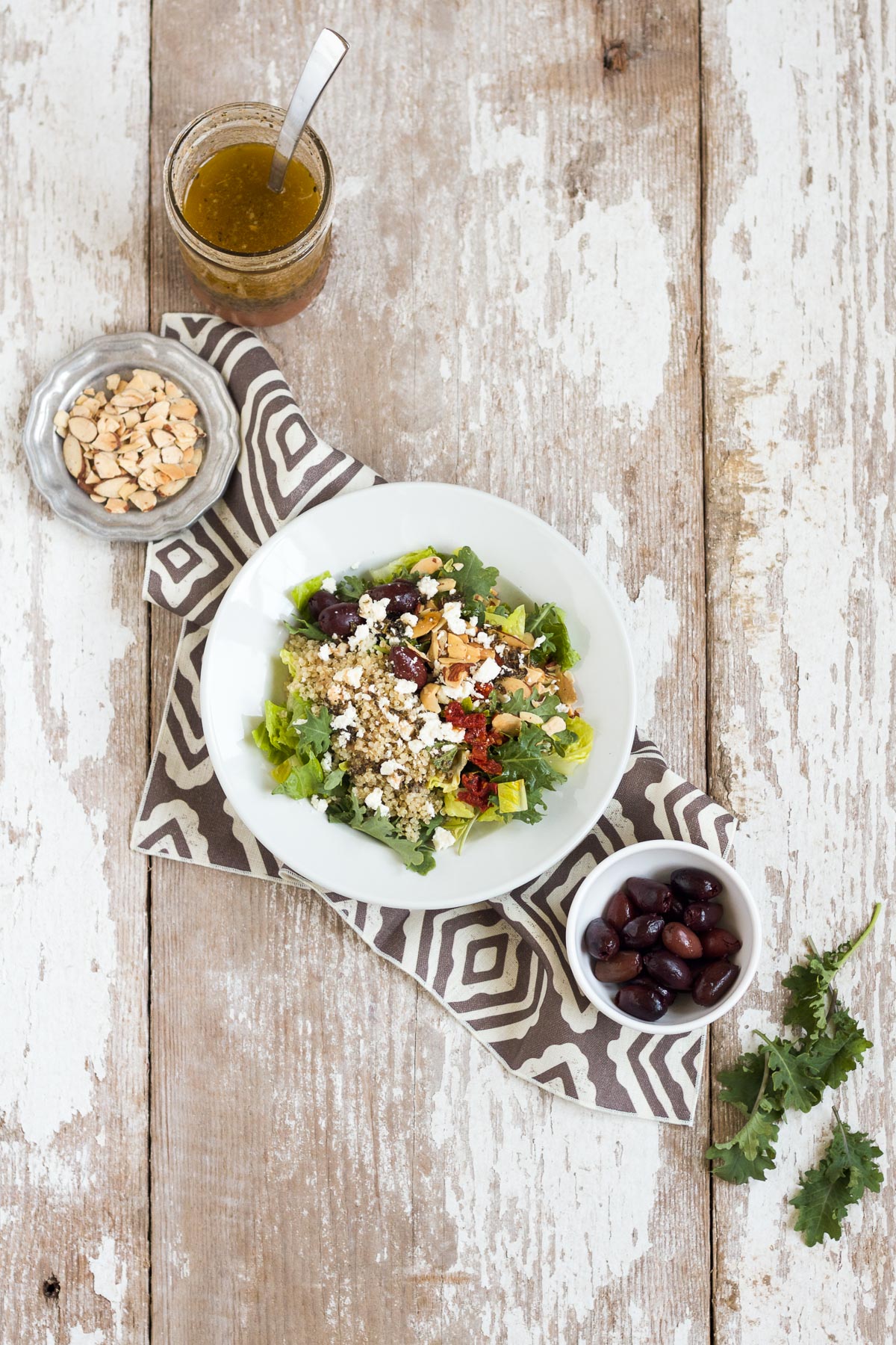 This Mediterranean Salad with Kale & Quinoa tastes just like the one served at Panera Bread. It's easy to make at home and is full of good-for-you ingredients like kale, quinoa, and almonds.