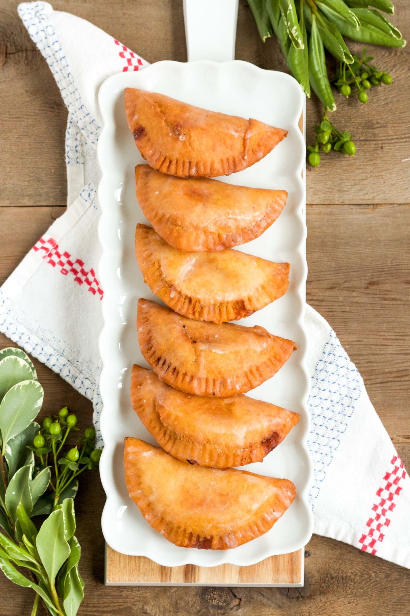 These delicious fried hand pies are filled with homemade peach jam, and are topped with a sweet, sugary glaze!