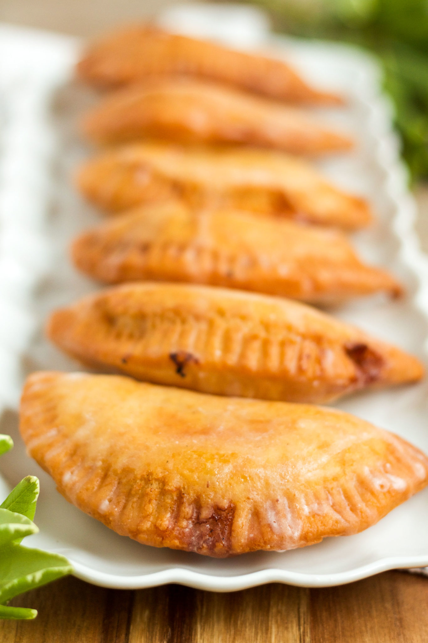These delicious fried hand pies are filled with homemade peach jam, and are topped with a sweet, sugary glaze!
