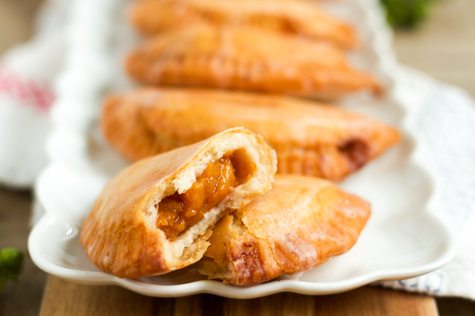 These delicious fried hand pies are filled with homemade peach jam, and are topped with a sweet, sugary glaze!