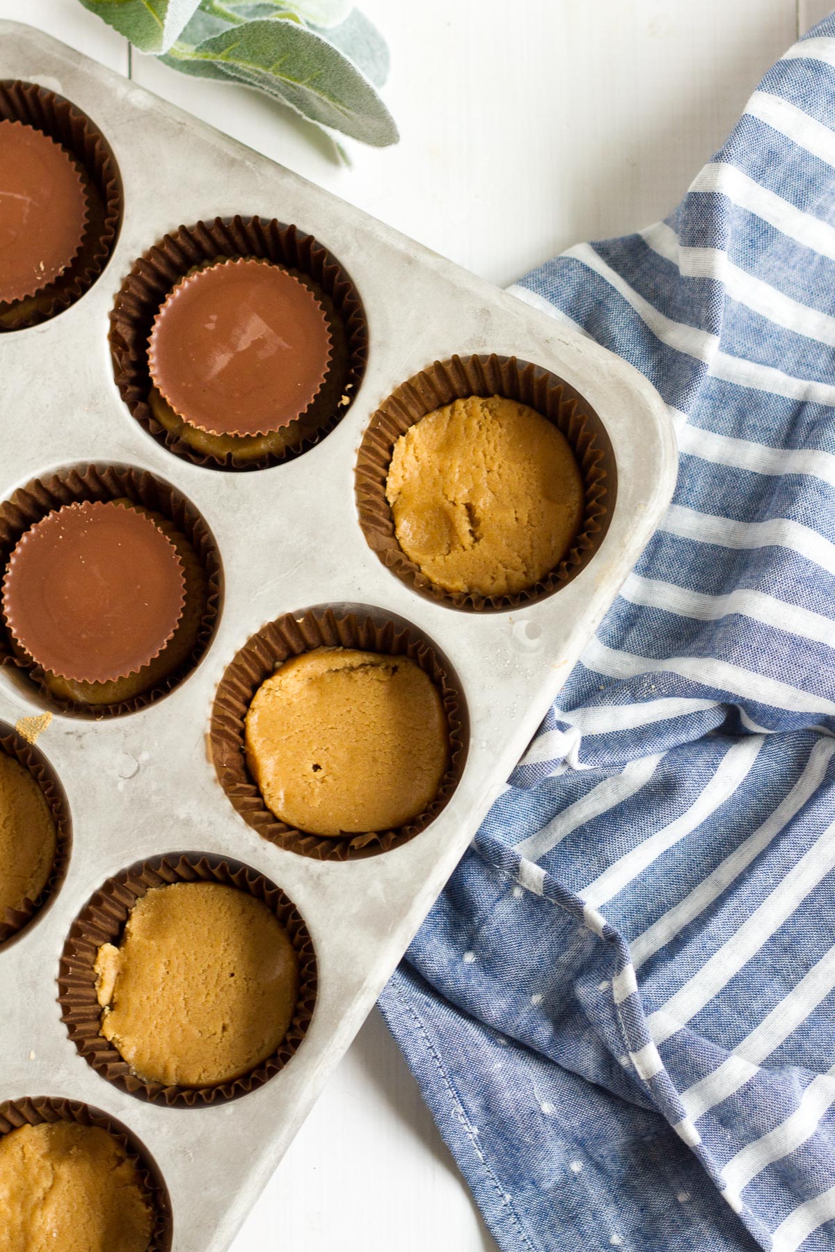 Peanut butter cup brownies have a delicious peanut butter cookie on the bottom, a fudge brownie layer on top, and a peanut butter cup sandwiched in between!