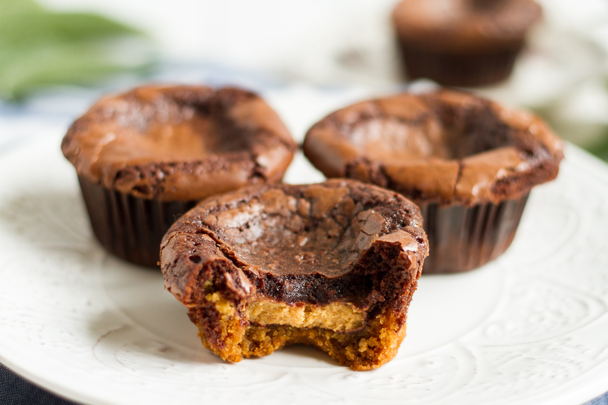 Peanut butter cup brownies have a delicious peanut butter cookie on the bottom, a fudge brownie layer on top, and a peanut butter cup sandwiched in between!