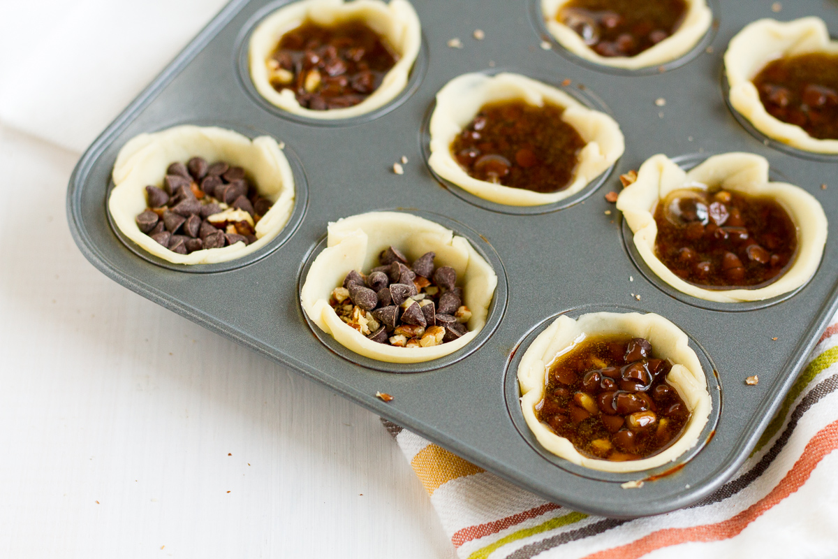 These mini chocolate pecan pies are delicious and easy to make. They're a perfect addition to your Thanksgiving or Friendsgiving dessert table!