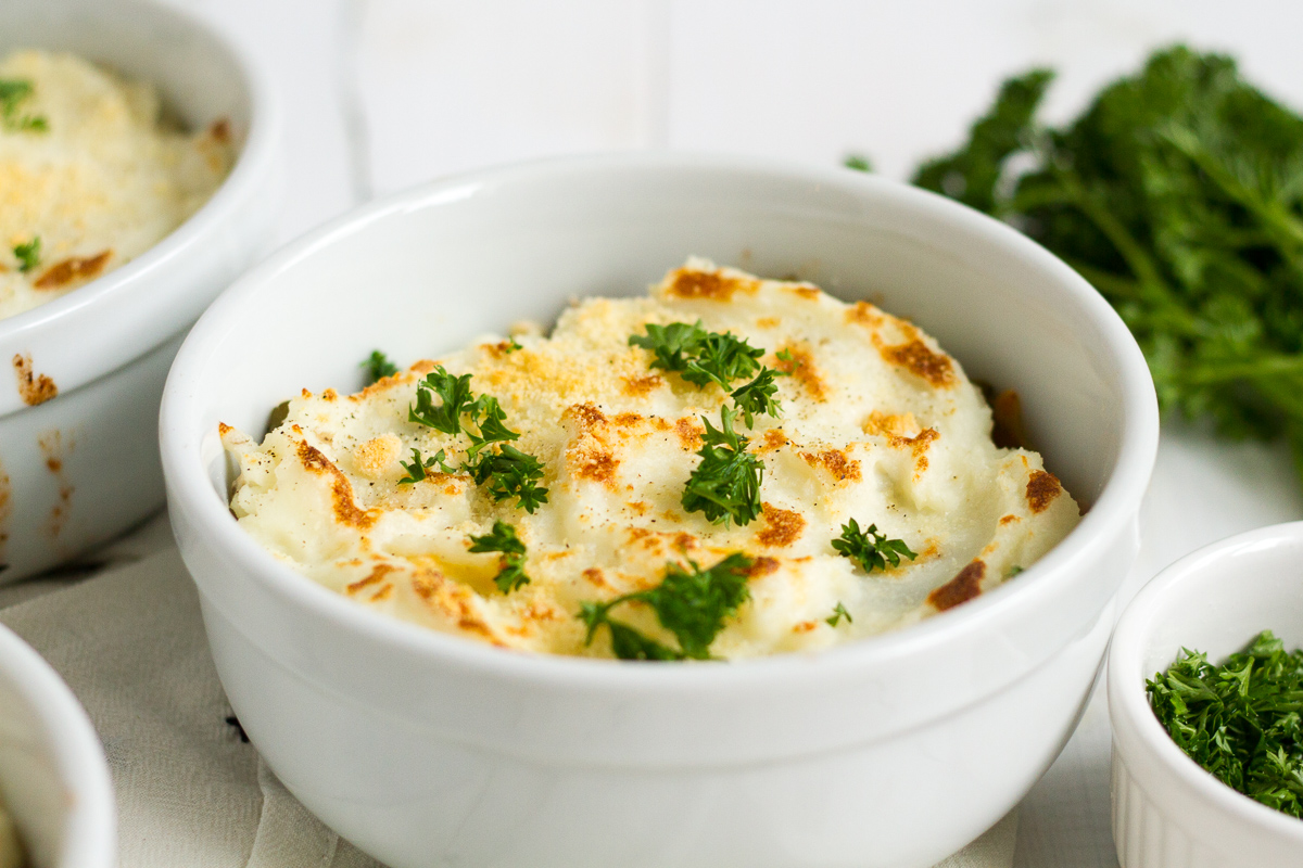 Shepherd's pie is one of my family's favorite easy dinners. These individual italian-style shepherd's pies have a delicious filling with herbs and tomatoes, and a sprinkling of parmesan cheese on top.