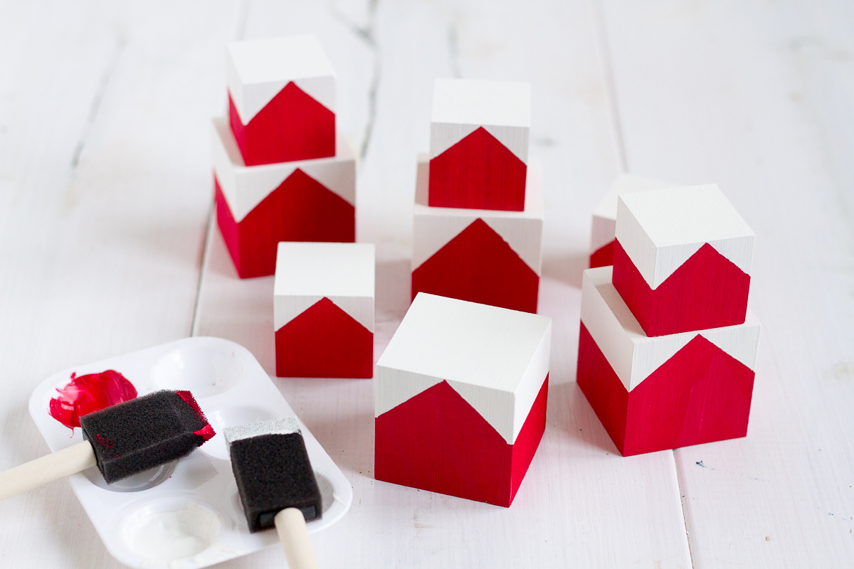 These cute and easy DIY Norwegian Christmas House blocks are inspired by the red and white houses tucked into the hillsides of fjord country.