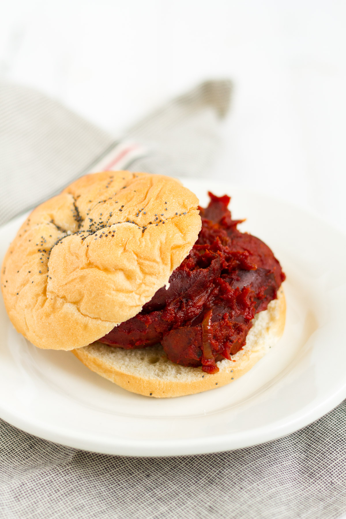 Tomato-braised sausage sandwiches with onions and peppers