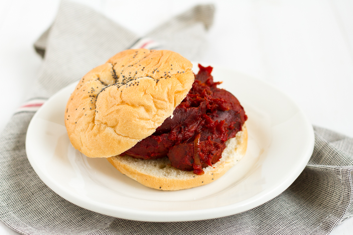 Tomato-braised sausage sandwiches with onions and peppers