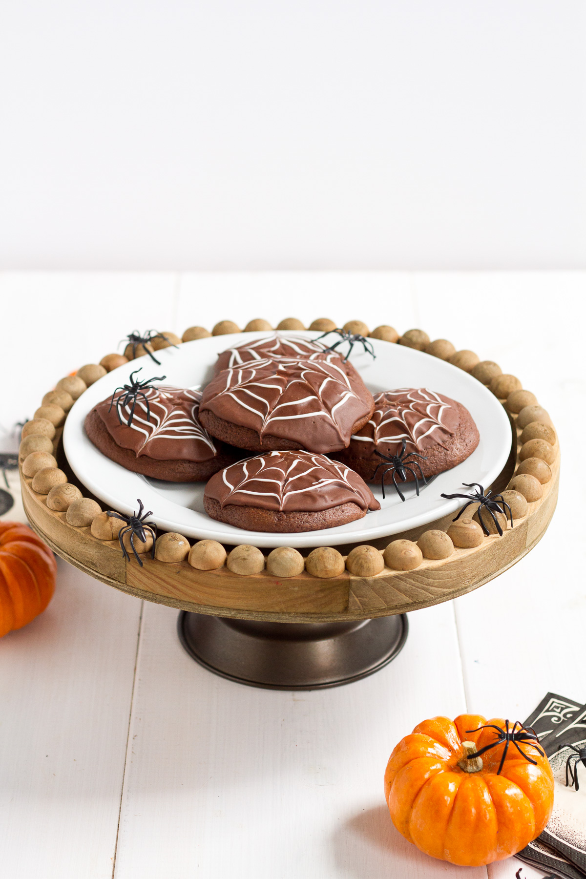 Deliciously cakey chocolate cookies dipped in a rich, homemade chocolate glaze and decorated with white icing spider webs. Perfect for Halloween!