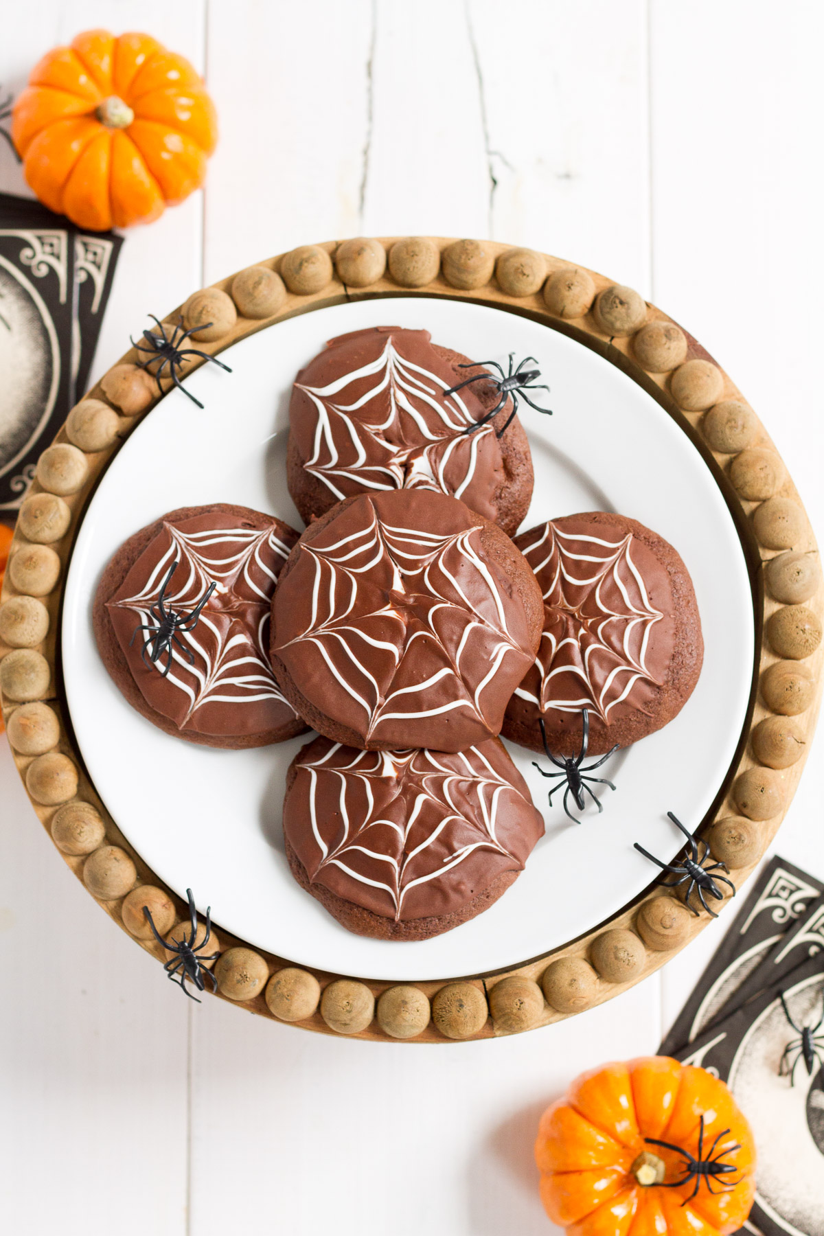 Deliciously cakey chocolate cookies dipped in a rich, homemade chocolate glaze and decorated with white icing spider webs. Perfect for Halloween!