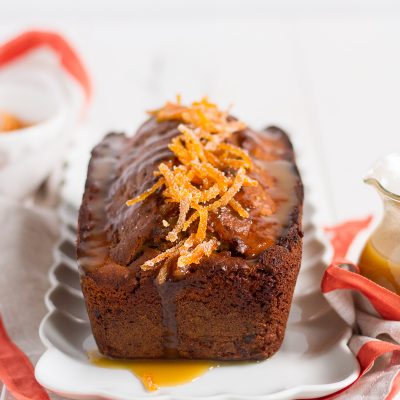 a delightful orange cake filled with dates and walnuts, and topped with a luxurious orange butterscotch sauce