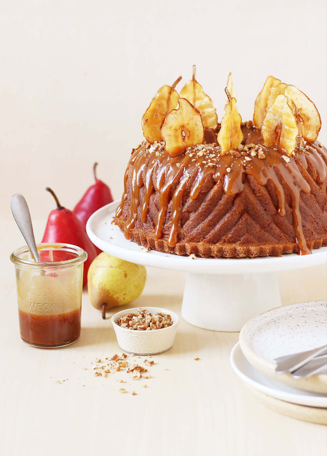 spiced pear bundt cake with salted caramel sauce and homemade pear crisps