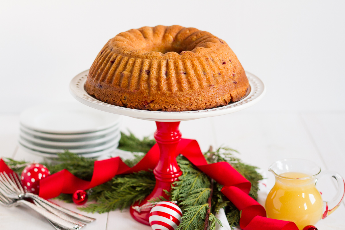 This fresh cranberry cake with hot butter sauce is simple and delicious. It is a breeze to make, but it looks beautiful and tastes luxurious. All of those things combine to make it the perfect dessert to serve to guests during the holidays.