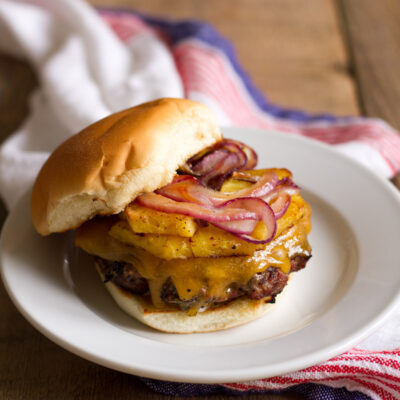 tropical bbq burgers with grilled pineapple, onions, and cheddar