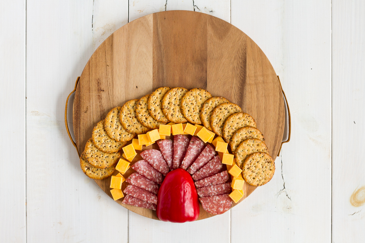 Adding more rows of snacks to your charcuterie board.