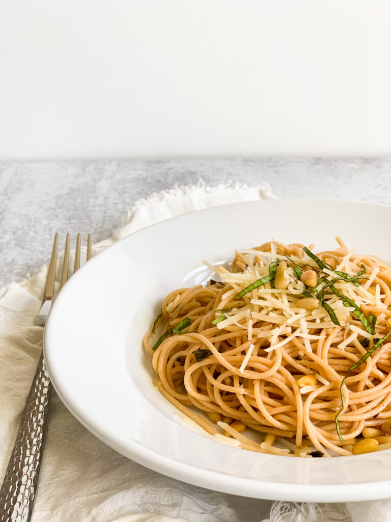 spaghetti with grated parmesan cheese, toasted pine nuts, fresh basic, and lemon juice