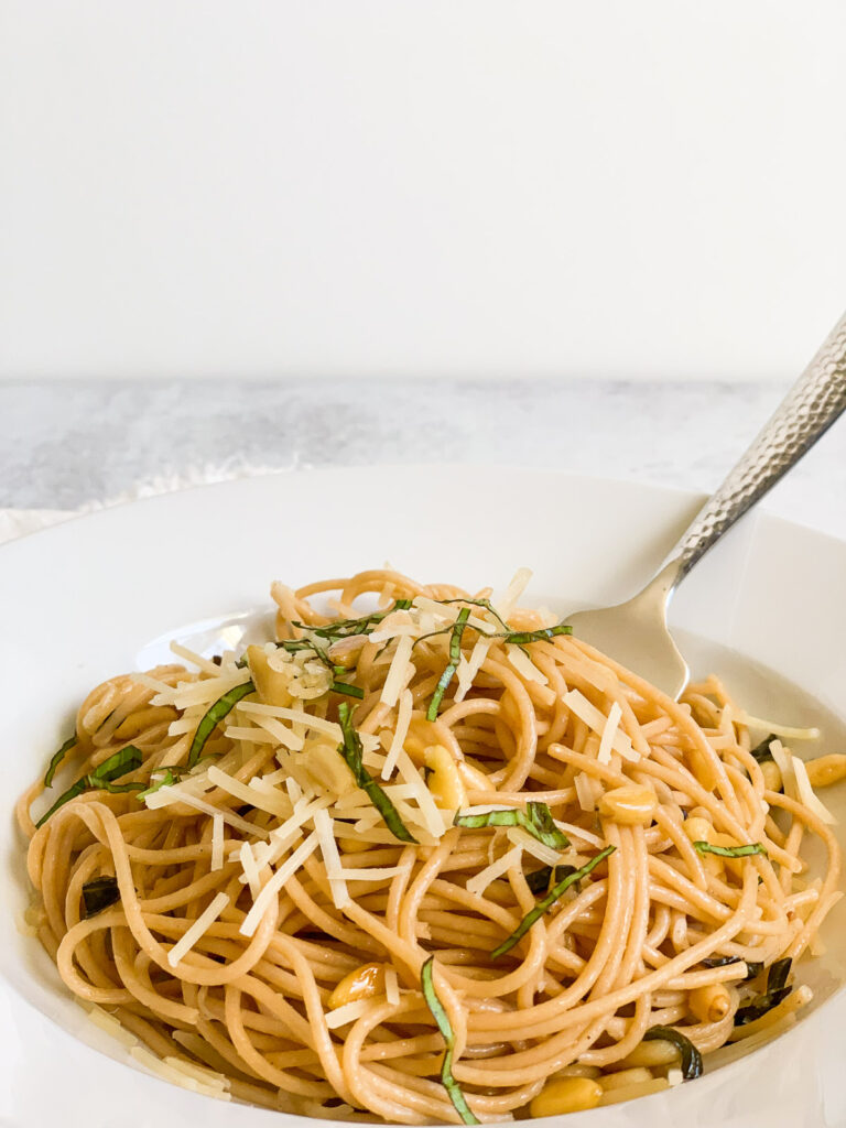 Lemon garlic spaghetti with toasted pine nuts, chopped basil, and parmesan cheese